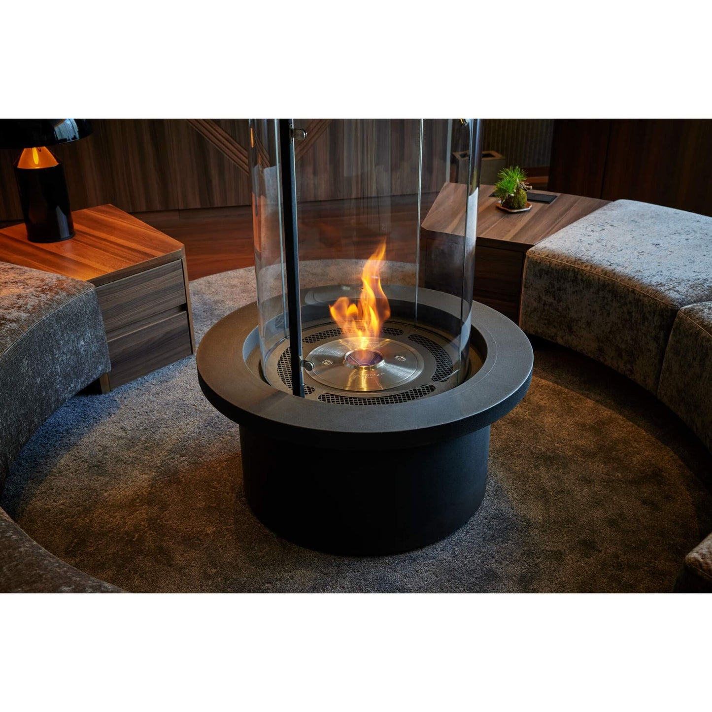 Modern indoor fire pit with flames in a living room setting