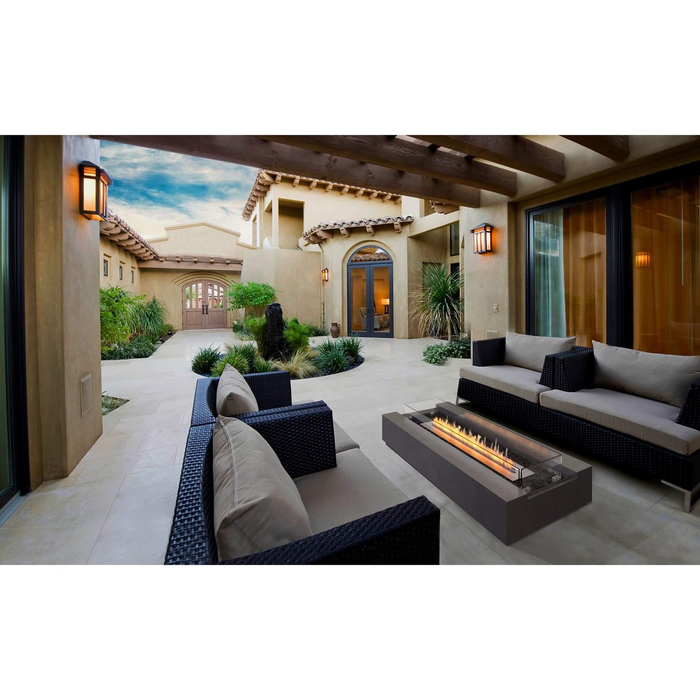 Ecosmart Fire Cosmo 50 Linear Bio Ethanol Concrete Fire Pit Coffee Table in Graphite black situated in an outdoor lounge area