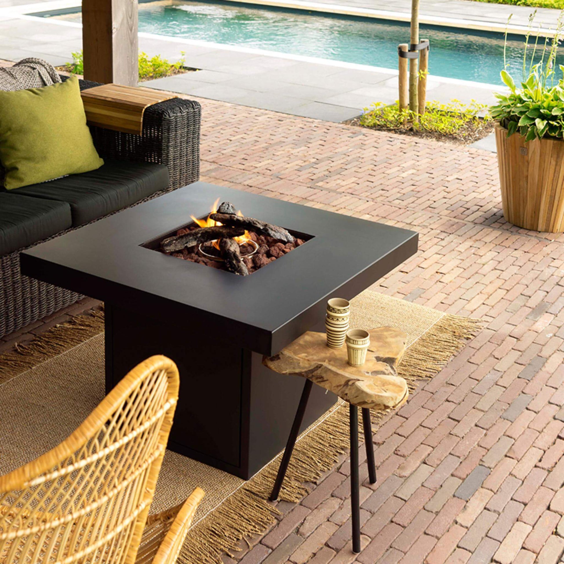 Cosibrixx 90 Anthracite Gas Fire Pit Table with lit fire in outdoor garden setting