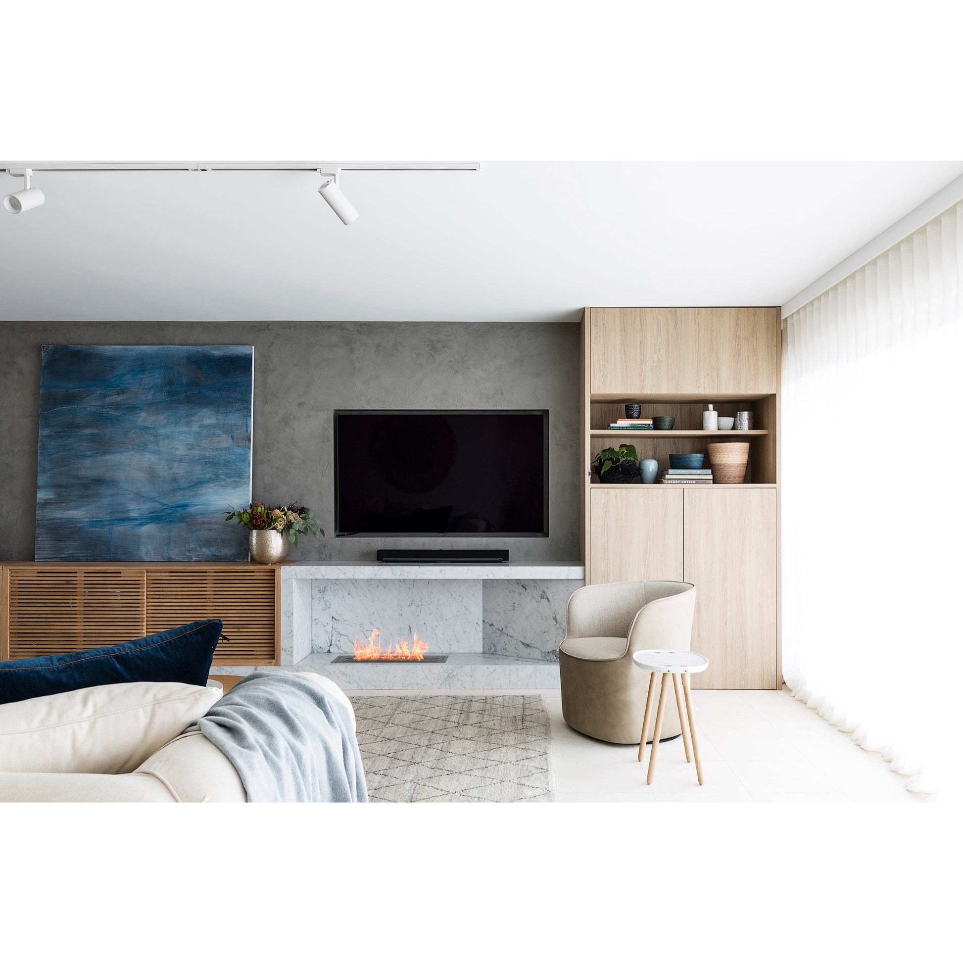 Modern living room with a fireplace, television, and wooden cabinet.