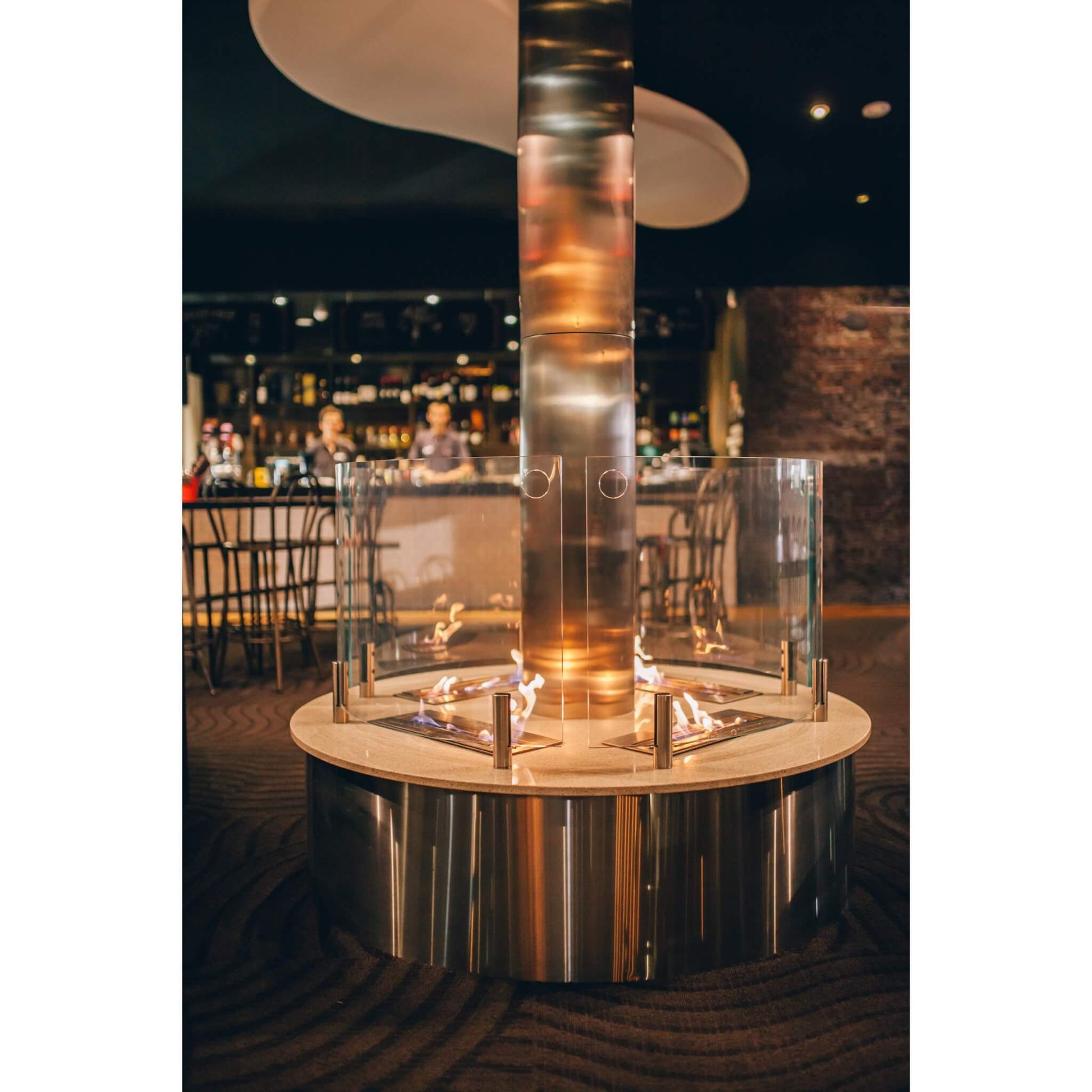 Round fire pit table with glass cover in an indoor setting
