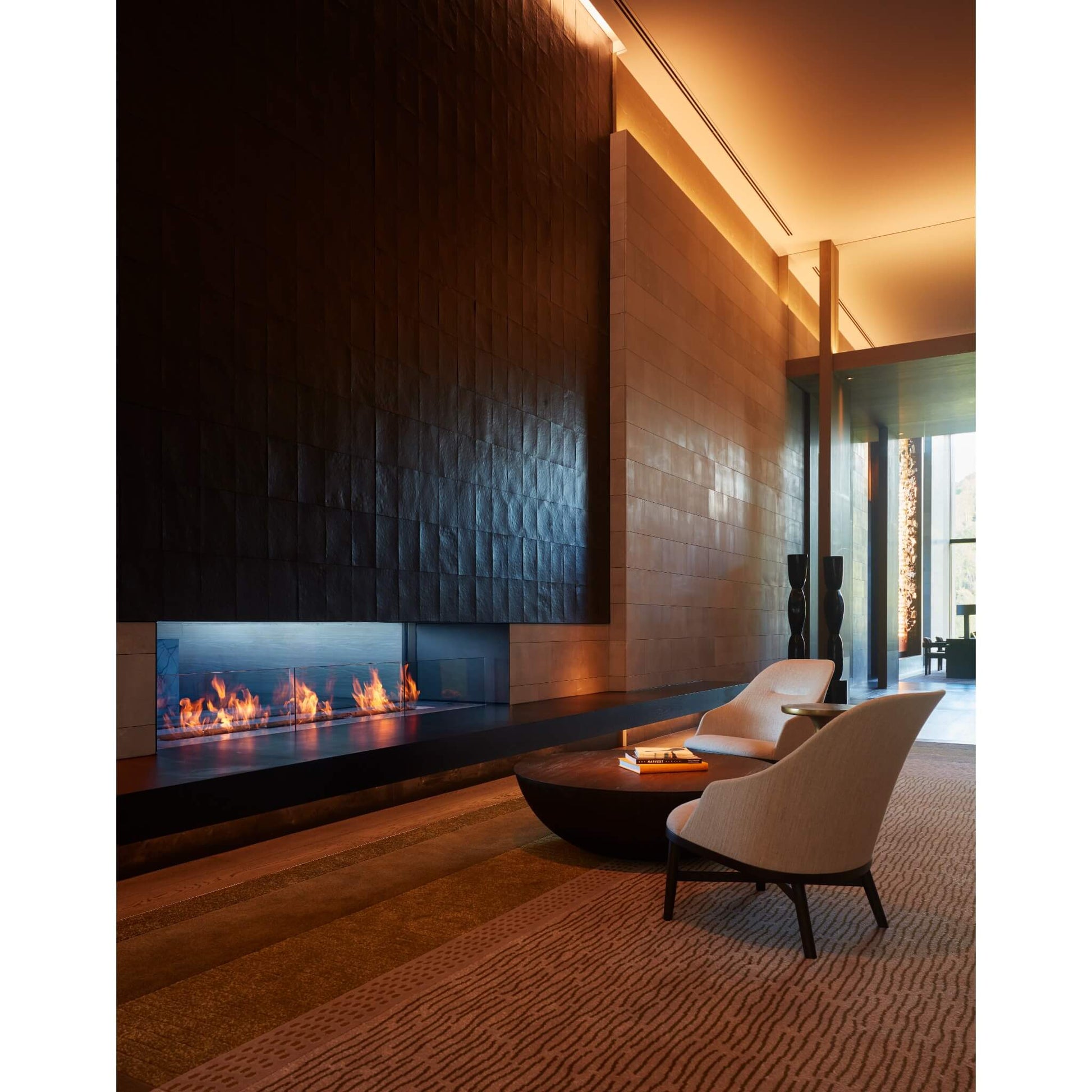 Modern living room with a fireplace and stylish furniture.