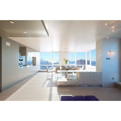 Modern kitchen and dining area with large windows overlooking a cityscape.