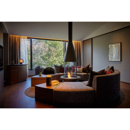 Modern living room with a fireplace and large windows.