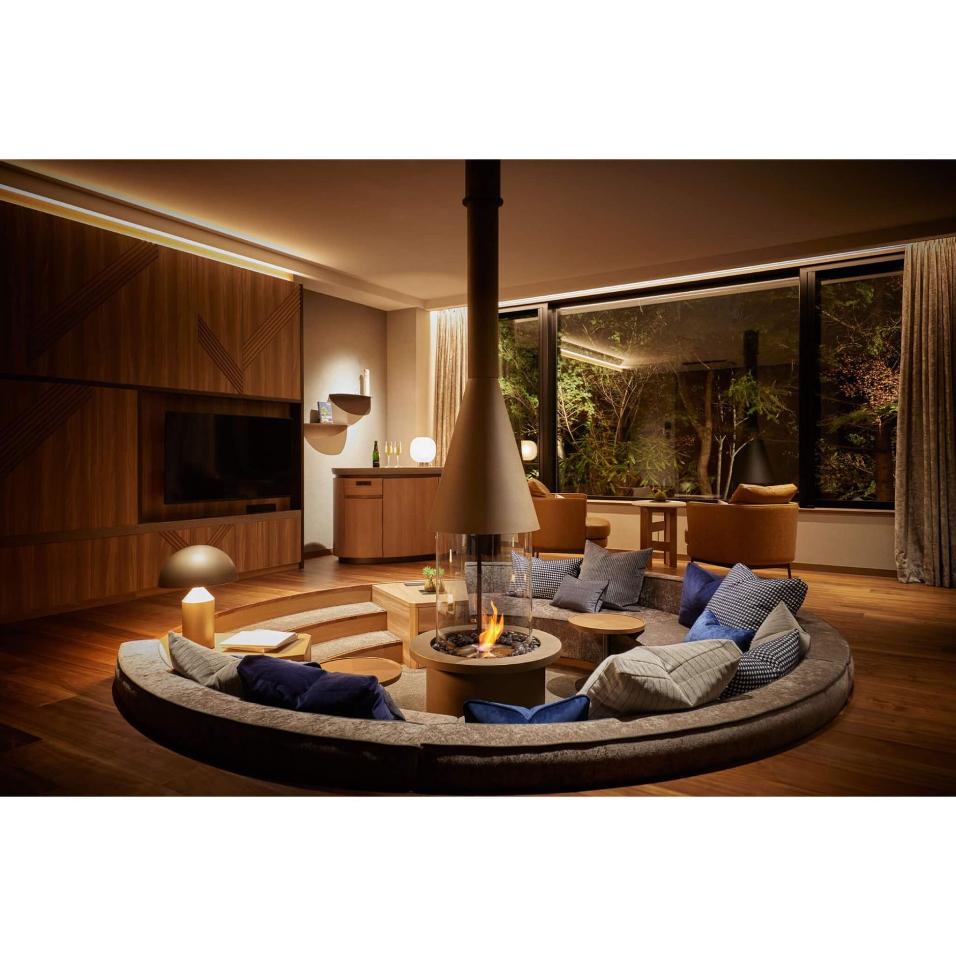 Modern living room with a fire pit and comfortable seating area.