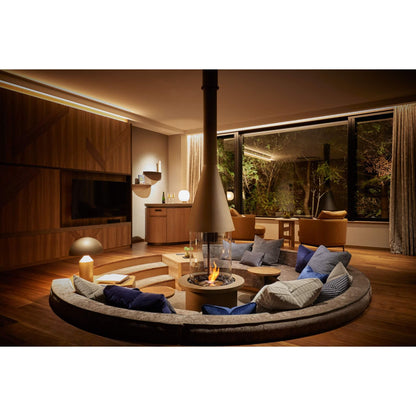 Modern living room with a fire pit and comfortable seating area.