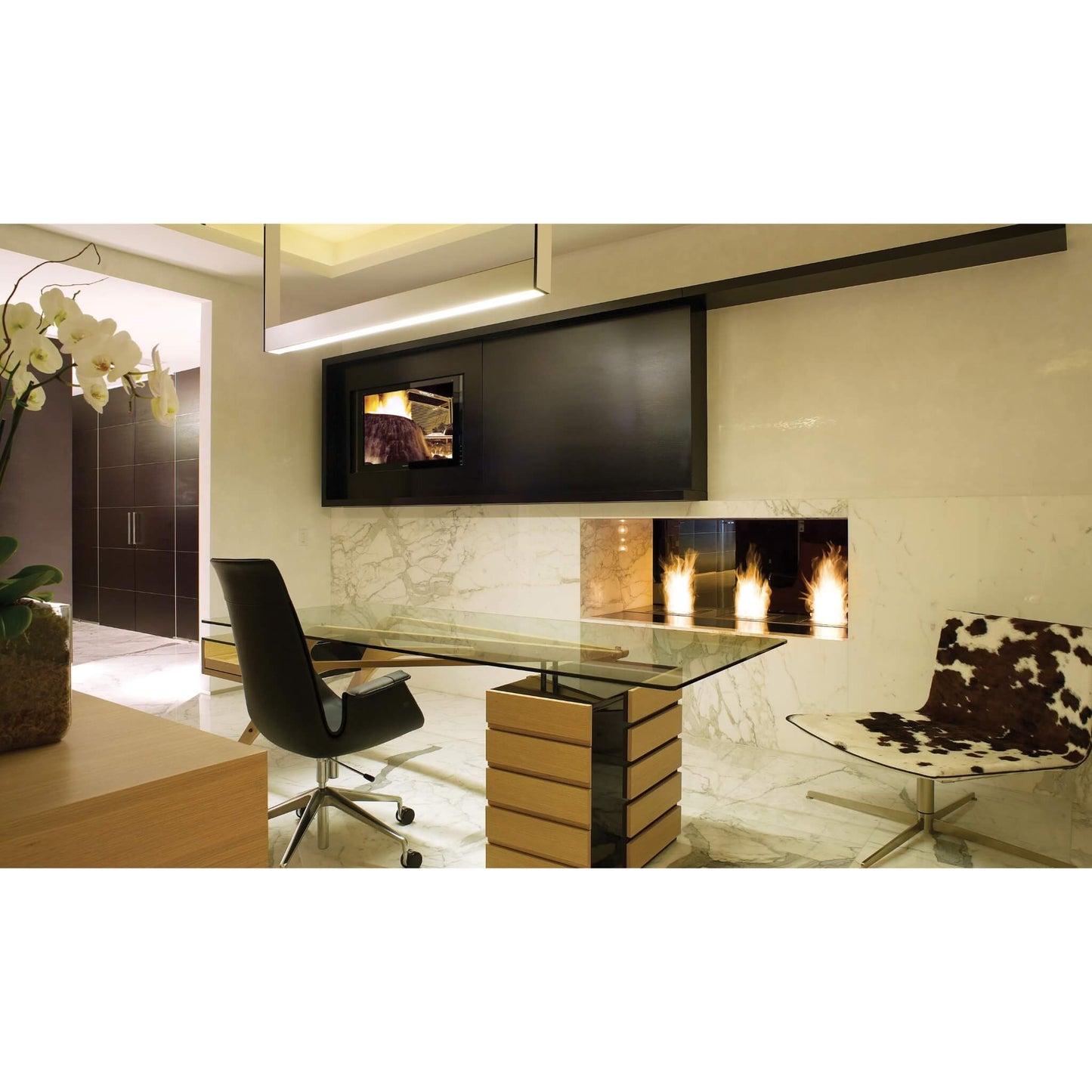 Modern office interior with a desk, chair, and wall-mounted TV.