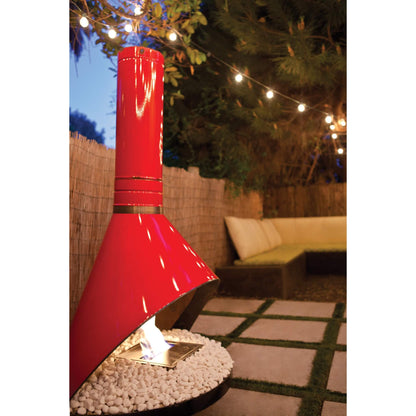 Red outdoor heater in a garden setting with string lights and a couch.
