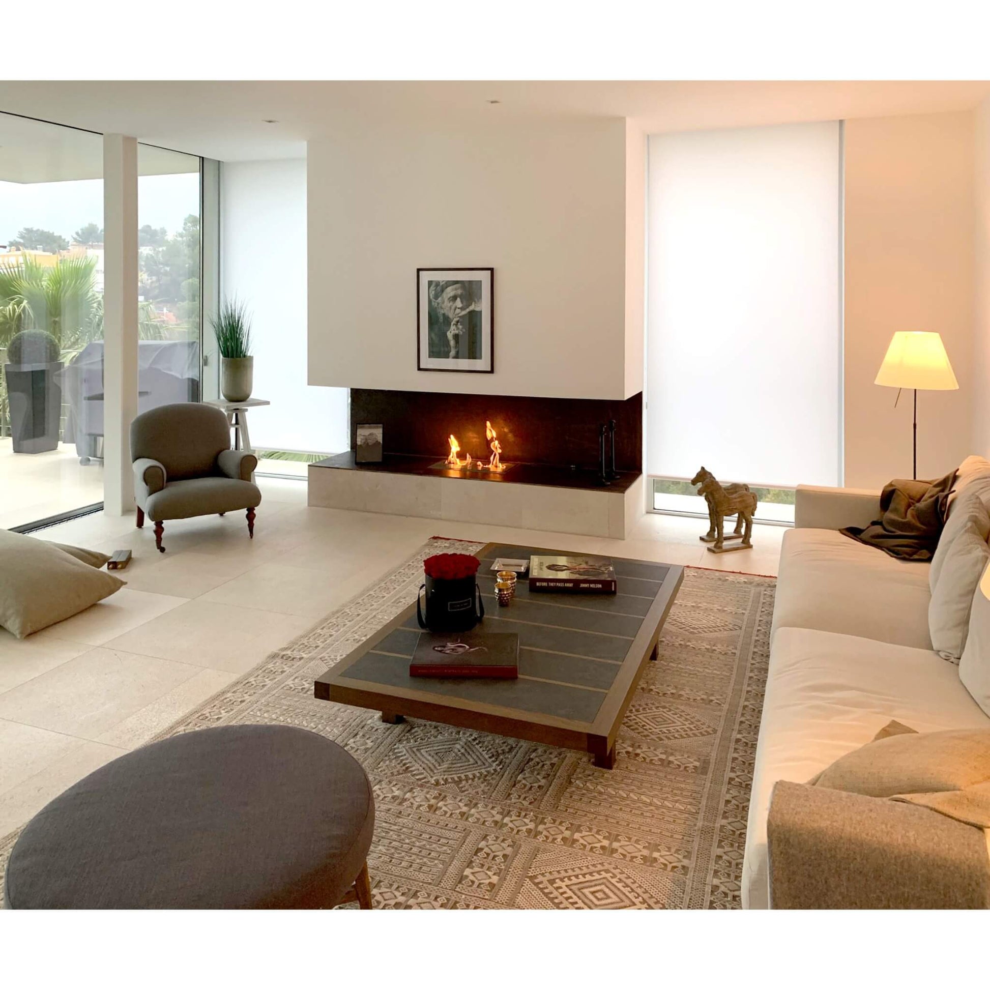 Modern living room with a fireplace, sofa, and coffee table.