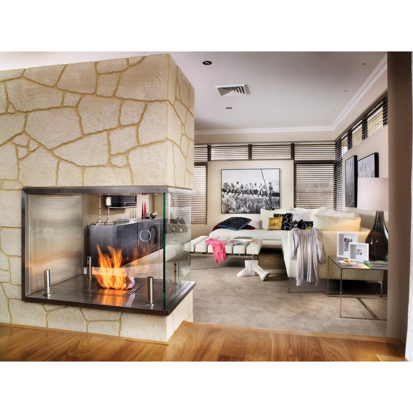 Modern living room with a stone fireplace and stylish decor.