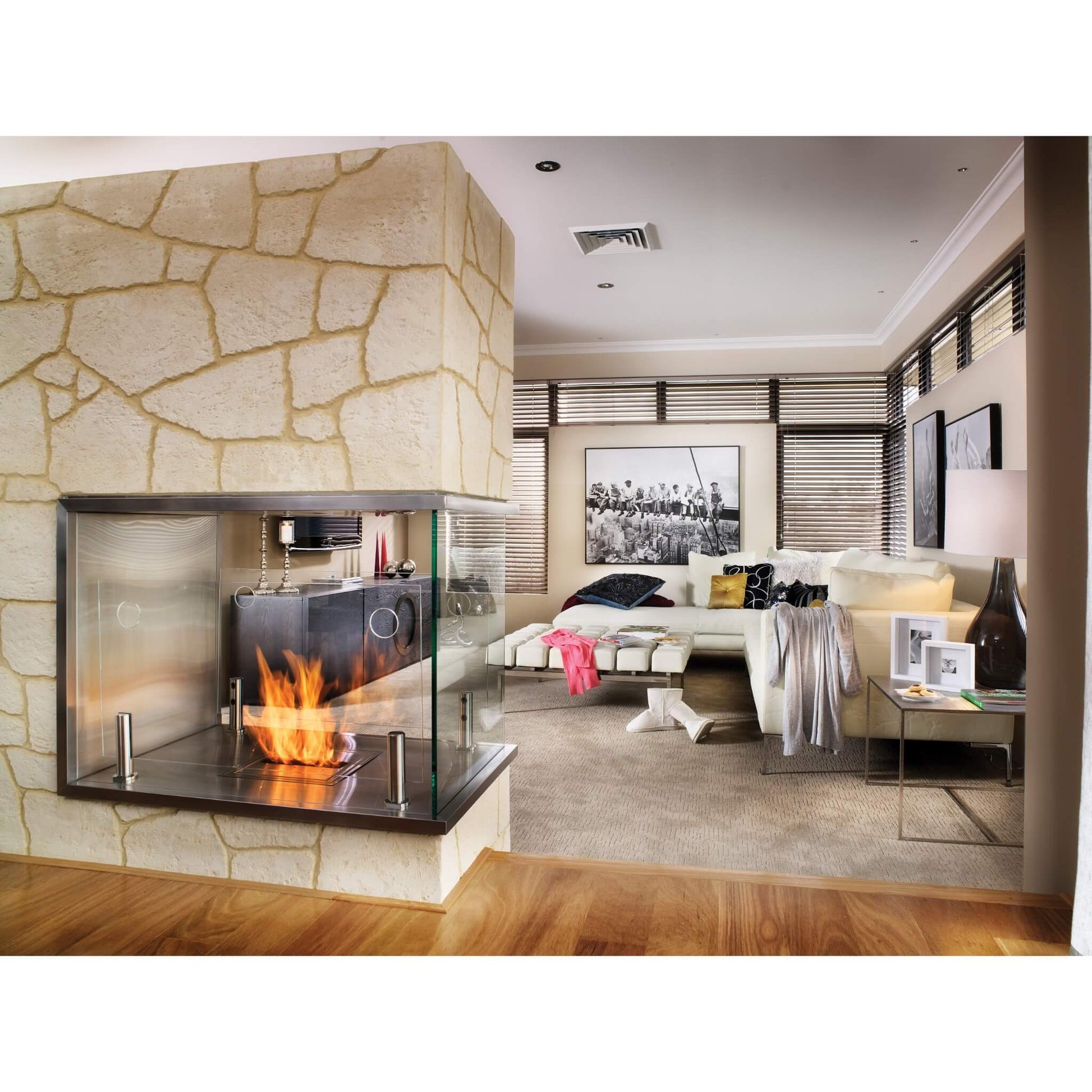 Modern living room with a stone fireplace and stylish decor.