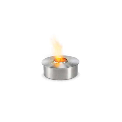 Stainless steel tealight holder with flame on a white background