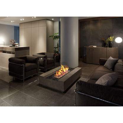 Cosmo 50 Linear Bio Ethanol Concrete Fire Pit Coffee Table in Natural grey situated in an indoor lounge area