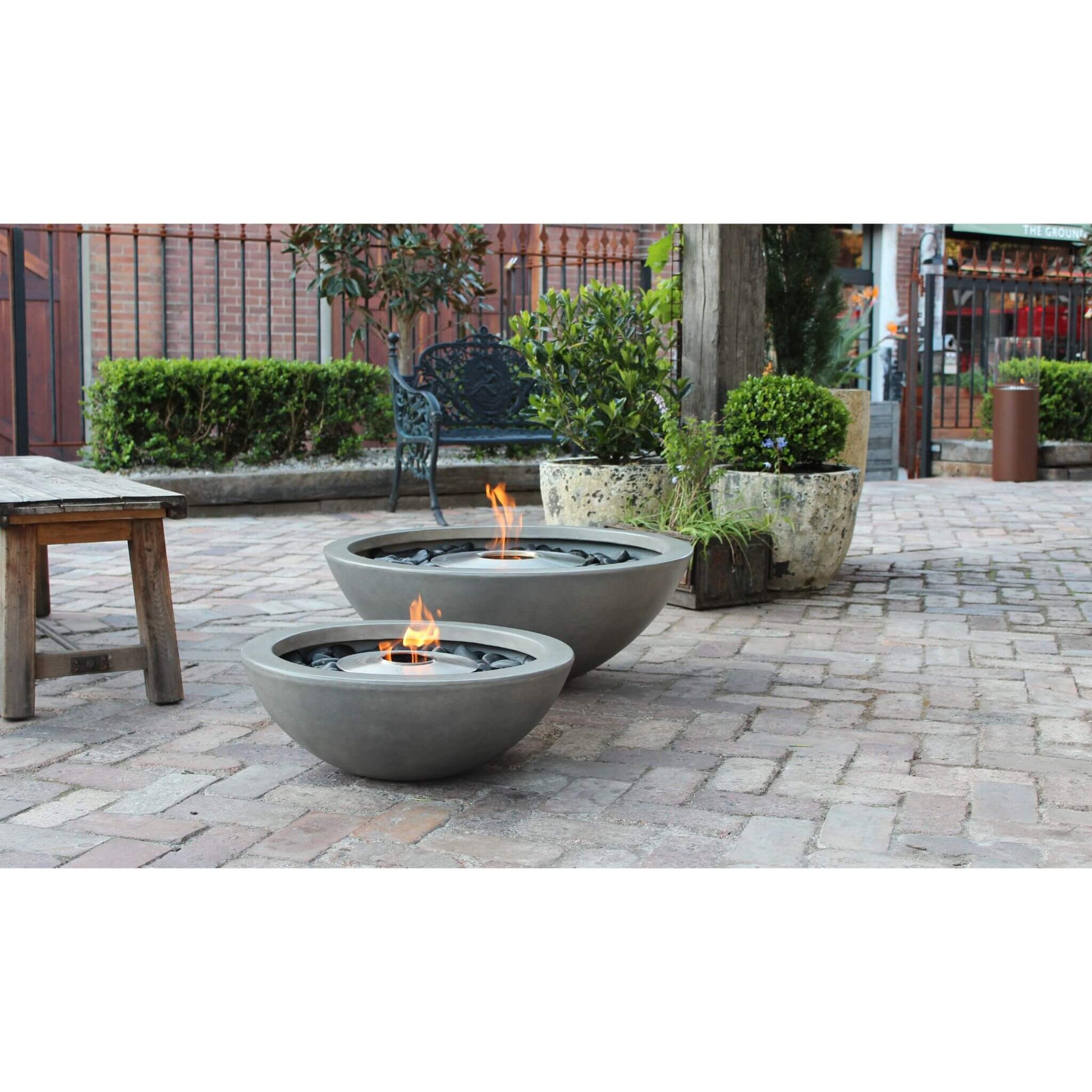 Ecosmart Fire Mix 600 & Mix 850 bioethanol fire pit bowls in grey concrete with stainless steel burner positioned outdoor on patio grounds