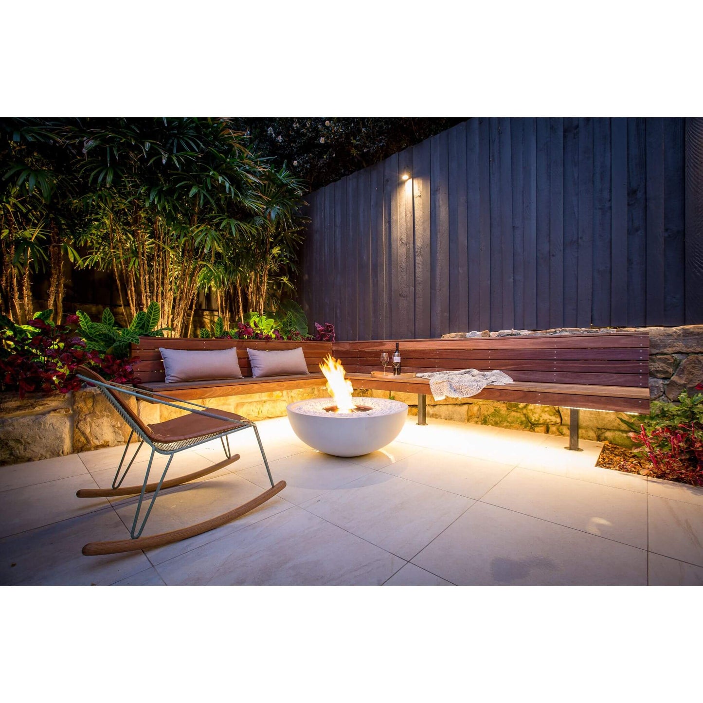 Ecosmart Fire Mix 850 bioethanol fire pit bowl in white concrete with a stainless steel burner positioned on outdoor garden patio area